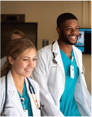 Photo of two medical students smiling and walking