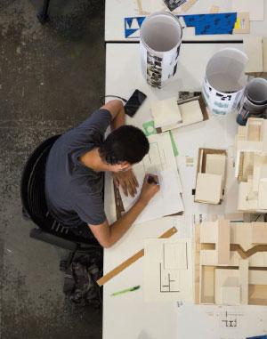 Photo of architecture student working at the their desk from an overhead perspective