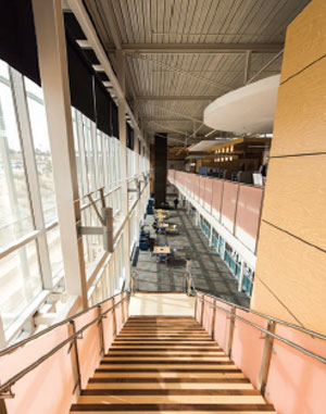 Photo of from the top of a staircase within a building on campus